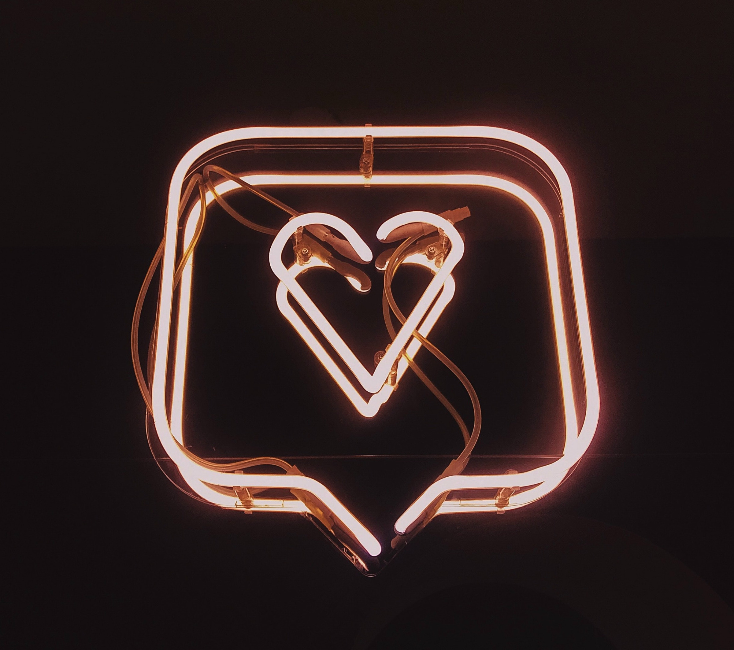 A pink neon heart surrounded by notification box